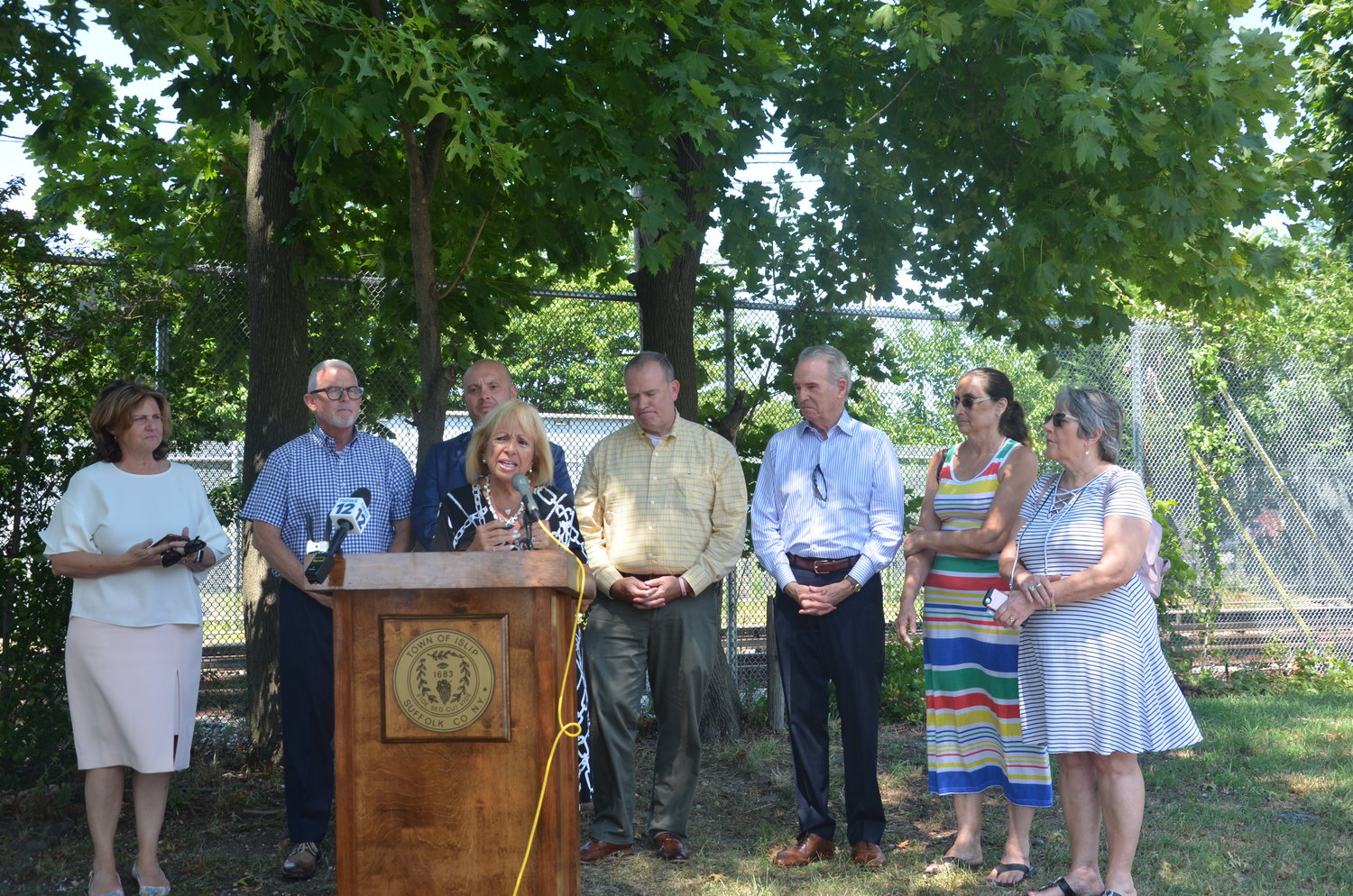 Angie Carpenter speaks at a press conference announcing a $3 million grant for a new sewer connection for downtown Central Islip.